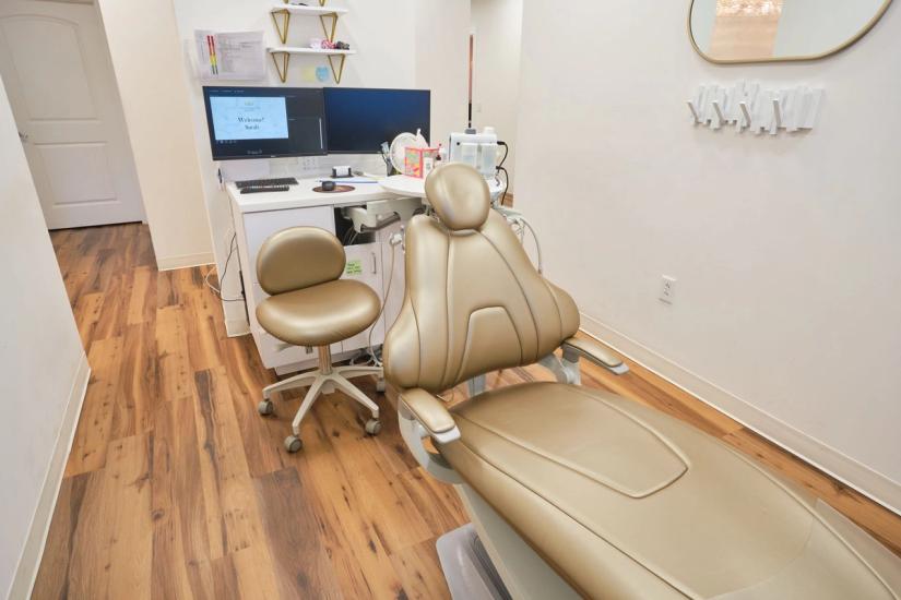 a waiting room with chairs and a flat screen tv on the wall . a waiting room with chairs and a flat screen tv on the wall .